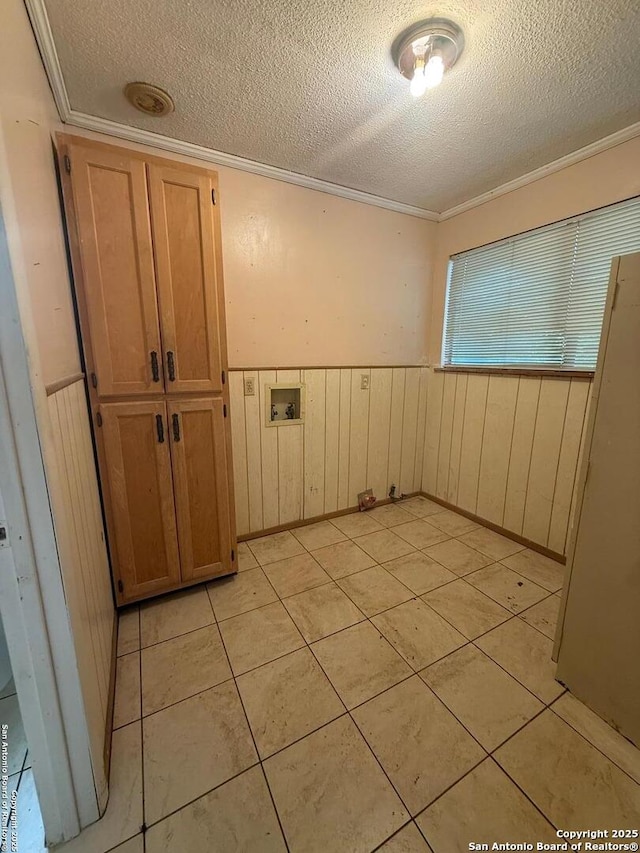 254 W Greenway Ave, San Antonio, TX 78226 - unfurnished room featuring a textured ceiling, a wainscoted wall, ornamental molding, light tile patterned flooring, and wood walls