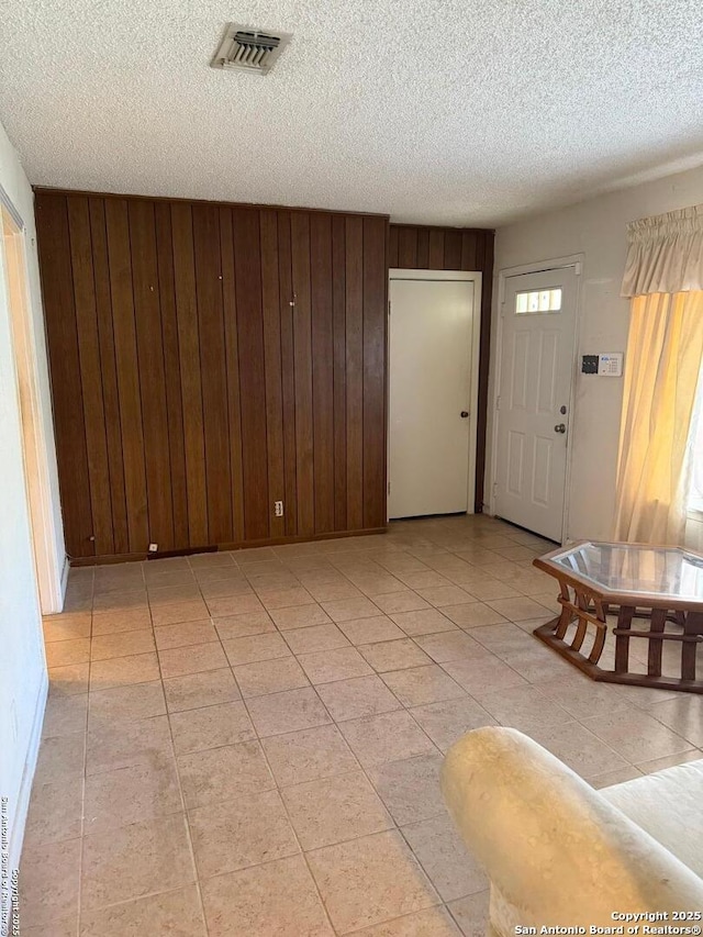 254 W Greenway Ave, San Antonio, TX 78226 - living area featuring a textured ceiling, wood walls, and light tile patterned flooring