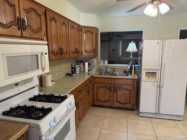 254 W Greenway Ave, San Antonio, TX 78226 - kitchen featuring white appliances, a sink, a ceiling fan, tile counters, and decorative backsplash