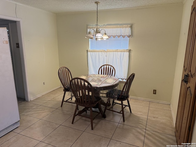 254 W Greenway Ave, San Antonio, TX 78226 - dining space with a chandelier, a textured ceiling, light tile patterned floors, and baseboards