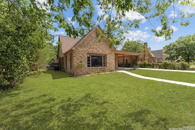 427 Donaldson, San Antonio, TX 78201 - view of front of home with brick siding, a front lawn, an attached carport, and central AC unit