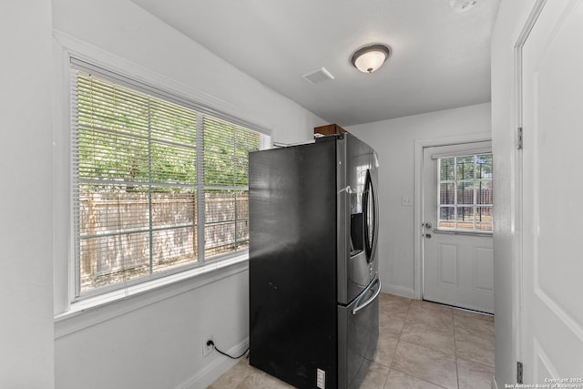 427 Donaldson, San Antonio, TX 78201 - kitchen featuring stainless steel refrigerator with ice dispenser, light tile patterned flooring, and baseboards