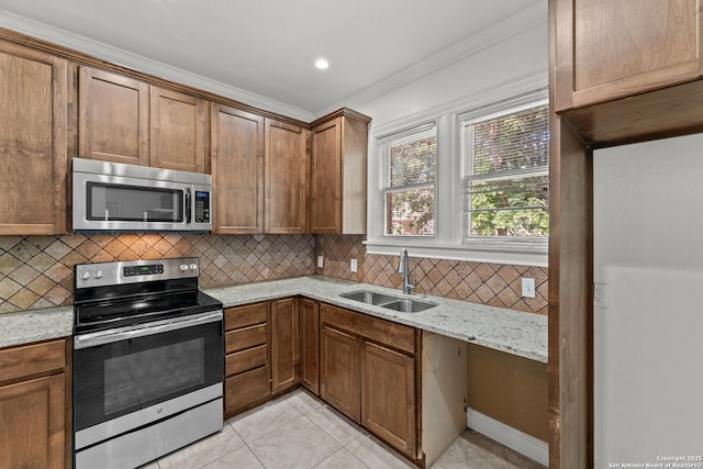 427 Donaldson, San Antonio, TX 78201 - kitchen with stainless steel appliances, a sink, decorative backsplash, light tile patterned flooring, and light stone countertops
