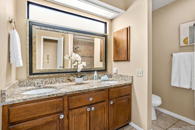 7738 Chambers Unit 612, San Antonio, TX 78229 - full bath featuring tile patterned floors, double vanity, toilet, and baseboards