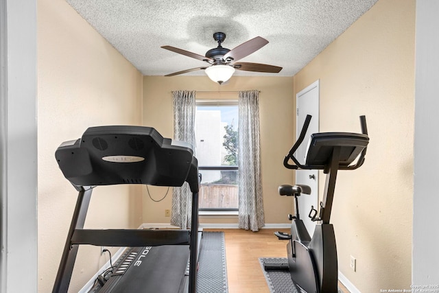 7738 Chambers Unit 612, San Antonio, TX 78229 - exercise room with a ceiling fan, wood finished floors, a textured ceiling, and baseboards