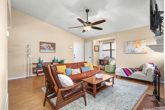 7738 Chambers Unit 612, San Antonio, TX 78229 - living room with vaulted ceiling, a ceiling fan, light wood-style flooring, baseboards, and a textured ceiling