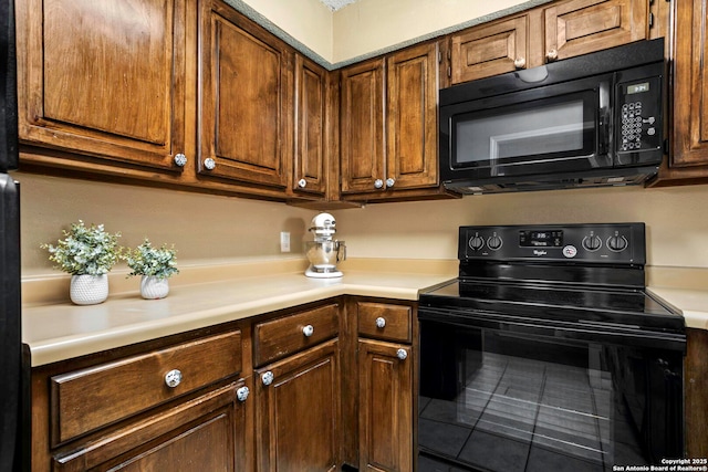 7738 Chambers Unit 612, San Antonio, TX 78229 - kitchen with black appliances, light countertops, and tile patterned flooring