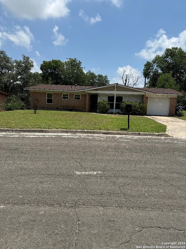 4606 Trailwood, San Antonio, TX 78228 - view of front of home with an attached garage, driveway, and a front yard