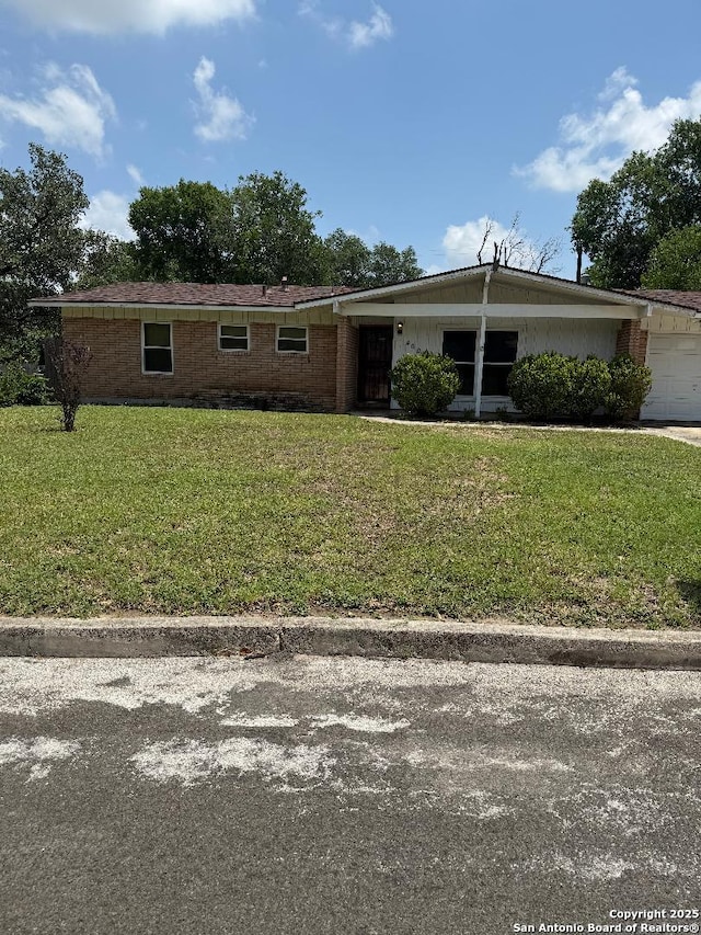 4606 Trailwood, San Antonio, TX 78228 - view of front of house with a garage, a front lawn, and brick siding