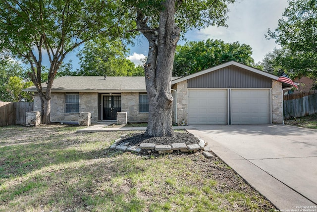 1111 Rio Linda, San Antonio, TX 78245 - ranch-style house with stone siding, concrete driveway, and a garage