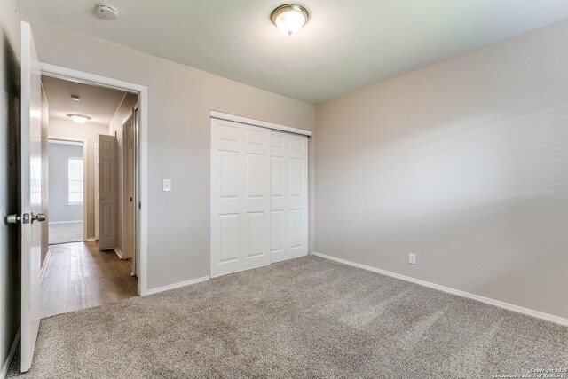 1111 Rio Linda, San Antonio, TX 78245 - unfurnished bedroom featuring carpet flooring, baseboards, and a closet