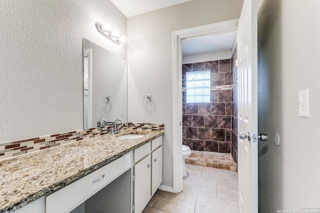 1111 Rio Linda, San Antonio, TX 78245 - full bathroom with vanity, toilet, tiled shower, a textured wall, and tile patterned floors