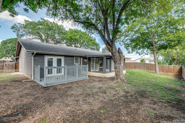 1111 Rio Linda, San Antonio, TX 78245 - rear view of house with a shingled roof, a fenced backyard, a chimney, a sunroom, and french doors
