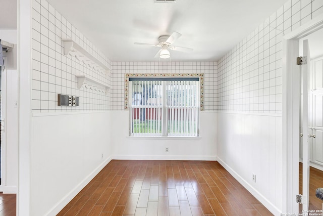 634 Golfcrest, Windcrest, TX 78239 - empty room with a ceiling fan, dark wood-style flooring, baseboards, wallpapered walls, and wainscoting