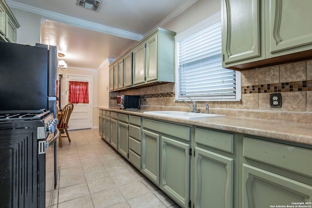 322 Pool, San Antonio, TX 78223 - kitchen with green cabinetry, appliances with stainless steel finishes, crown molding, a sink, and backsplash