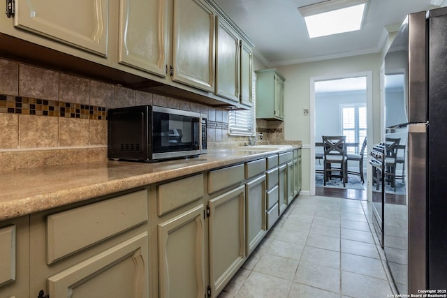 322 Pool, San Antonio, TX 78223 - kitchen with freestanding refrigerator, crown molding, decorative backsplash, light tile patterned floors, and a sink