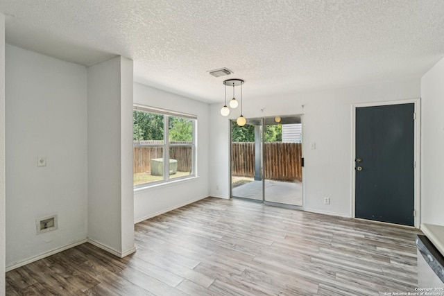 87 Kenrock Rdg, San Antonio, TX 78254 - spare room with plenty of natural light, wood finished floors, a textured ceiling, and baseboards