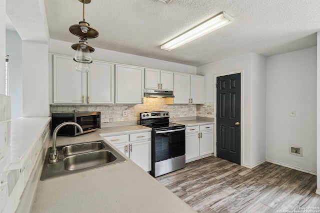 87 Kenrock Rdg, San Antonio, TX 78254 - kitchen with appliances with stainless steel finishes, under cabinet range hood, a sink, white cabinets, and decorative backsplash