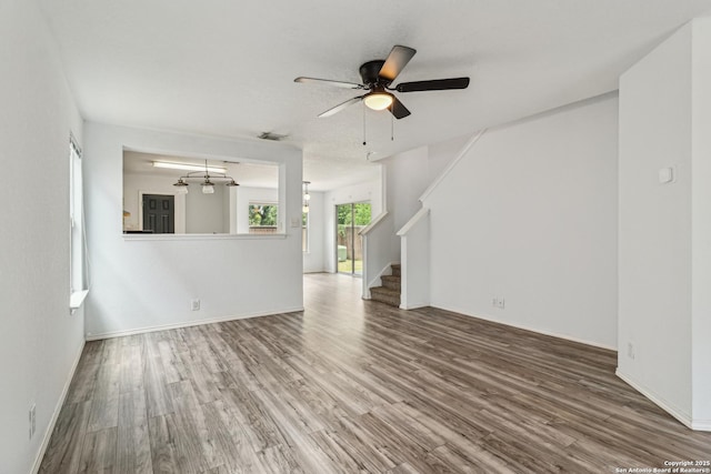 87 Kenrock Rdg, San Antonio, TX 78254 - unfurnished living room featuring wood finished floors, stairway, ceiling fan, and baseboards