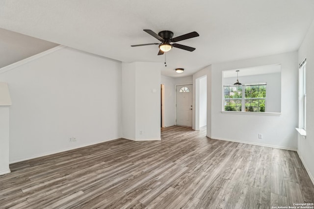 87 Kenrock Rdg, San Antonio, TX 78254 - unfurnished living room with wood finished floors, ceiling fan, and baseboards