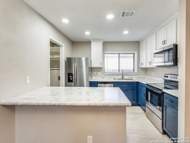 7363 Longing Trl, San Antonio, TX 78244 - kitchen with appliances with stainless steel finishes, blue cabinetry, a sink, white cabinets, and recessed lighting