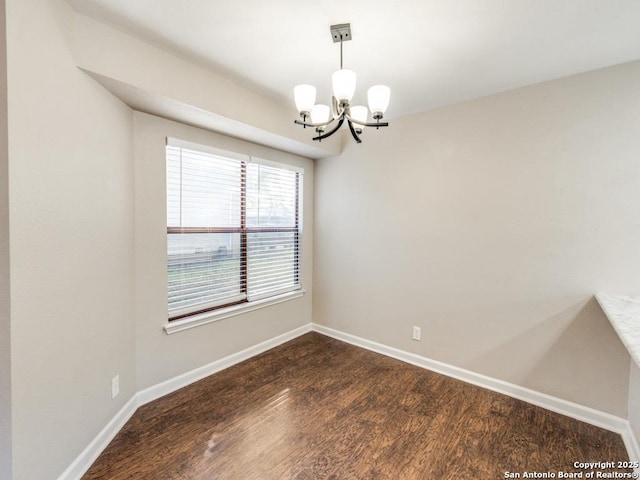 7363 Longing Trl, San Antonio, TX 78244 - unfurnished room with a chandelier, dark wood finished floors, and baseboards