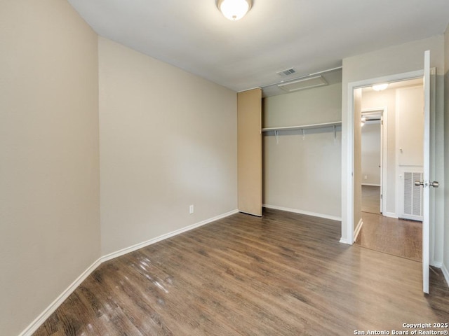7363 Longing Trl, San Antonio, TX 78244 - unfurnished bedroom with wood finished floors, attic access, a closet, and baseboards