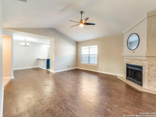 7363 Longing Trl, San Antonio, TX 78244 - unfurnished living room featuring ceiling fan, wood finished floors, a stone fireplace, a chandelier, and vaulted ceiling