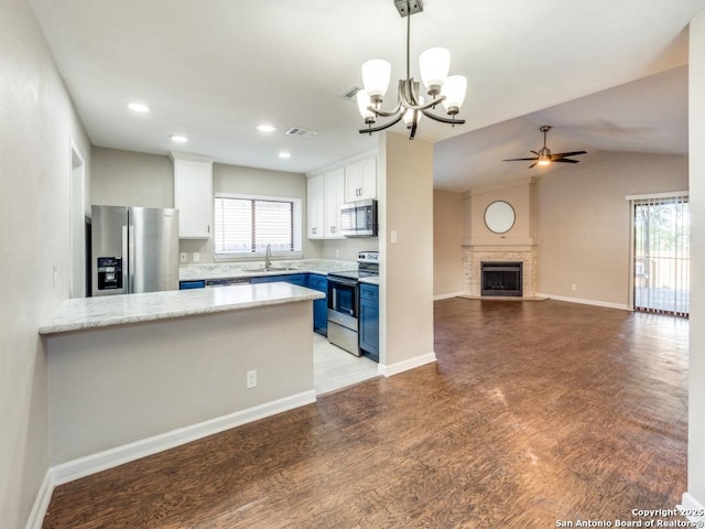 7363 Longing Trl, San Antonio, TX 78244 - kitchen with stainless steel appliances, a sink, blue cabinets, a ceiling fan, and light wood-style floors