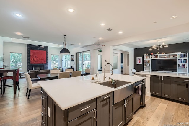 7 Saxby Gln, San Antonio, TX 78257 - kitchen featuring open floor plan, a sink, an island with sink, light countertops, and recessed lighting