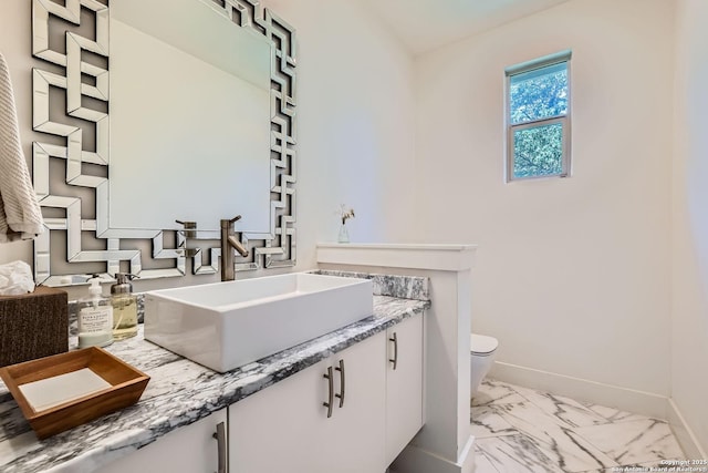 7 Saxby Gln, San Antonio, TX 78257 - bathroom featuring toilet, marble finish flooring, vanity, and baseboards