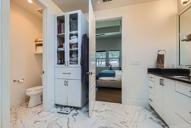 7 Saxby Gln, San Antonio, TX 78257 - bathroom with connected bathroom, vanity, baseboards, toilet, and marble look tile flooring