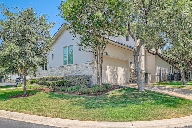 7 Saxby Gln, San Antonio, TX 78257 - view of property exterior featuring stone siding, driveway, a yard, stucco siding, and a garage