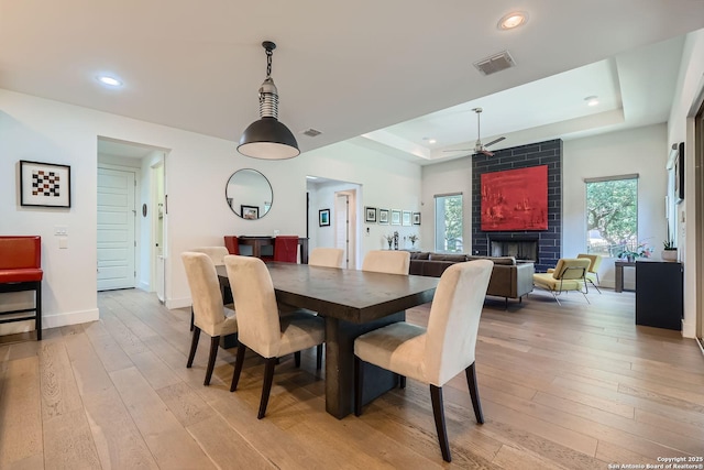 7 Saxby Gln, San Antonio, TX 78257 - dining area featuring plenty of natural light, light wood-style floors, baseboards, a raised ceiling, and recessed lighting