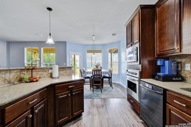 12535 Panola Way, San Antonio, TX 78253 - kitchen featuring appliances with stainless steel finishes, healthy amount of natural light, and tasteful backsplash