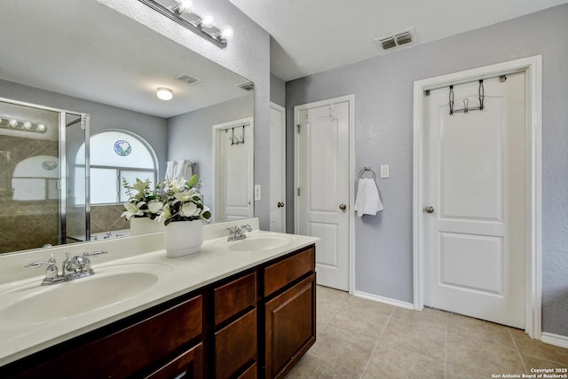 12535 Panola Way, San Antonio, TX 78253 - bathroom with double vanity, tile patterned floors, a stall shower, and baseboards