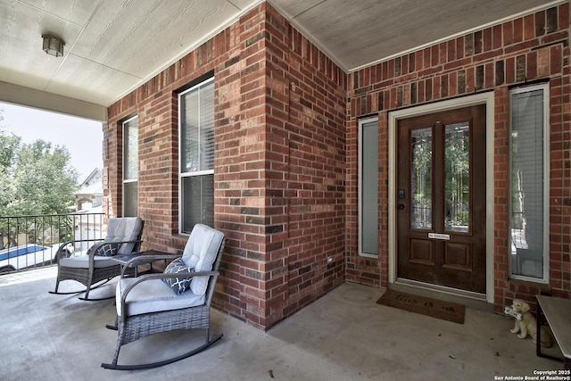 12535 Panola Way, San Antonio, TX 78253 - view of exterior entry with brick siding, a porch, and french doors