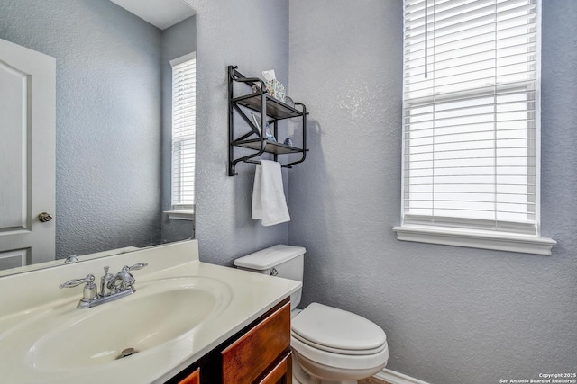 12535 Panola Way, San Antonio, TX 78253 - bathroom featuring a textured wall, toilet, and vanity