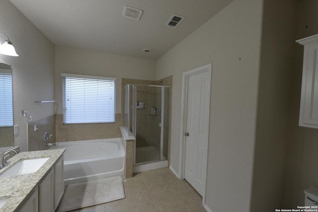 12610 Uhr Ln Unit 281, San Antonio, TX 78217 - full bath with tile patterned flooring, a bath, a stall shower, and vanity