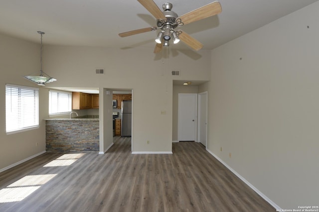 12610 Uhr Ln Unit 281, San Antonio, TX 78217 - unfurnished living room featuring baseboards, high vaulted ceiling, wood finished floors, and a ceiling fan