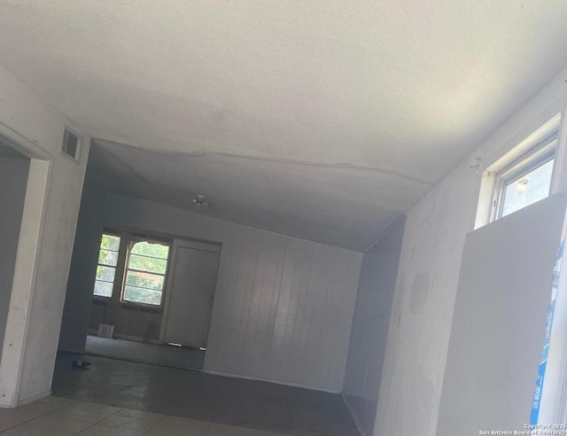 1743 Athel Ave, San Antonio, TX 78237 - hall with wooden walls and a textured ceiling