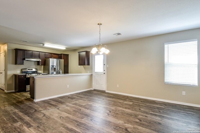 202 Reuben Kemper, San Antonio, TX 78220 - kitchen with stainless steel appliances, dark brown cabinetry, a chandelier, and dark wood-style flooring