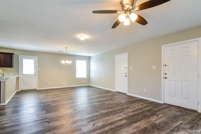 202 Reuben Kemper, San Antonio, TX 78220 - unfurnished living room with a chandelier, healthy amount of natural light, ceiling fan, and dark wood finished floors