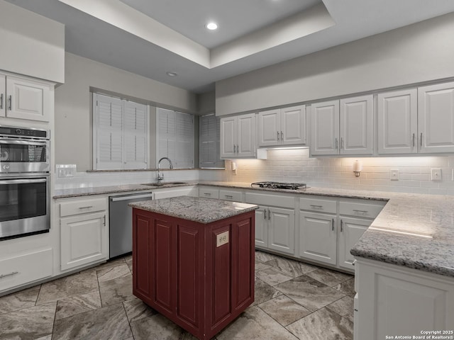 16 Cheshire, San Antonio, TX 78218 - kitchen with appliances with stainless steel finishes, a sink, white cabinetry, light stone counters, and recessed lighting