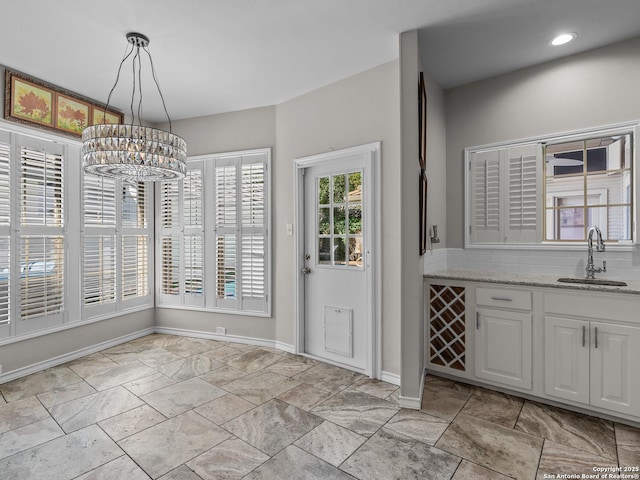 16 Cheshire, San Antonio, TX 78218 - unfurnished dining area featuring a sink, a chandelier, baseboards, and recessed lighting