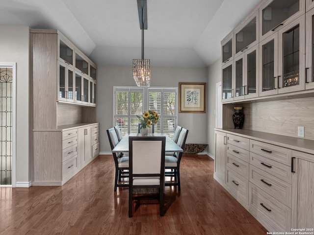 16 Cheshire, San Antonio, TX 78218 - dining space with dark wood finished floors, a chandelier, baseboards, and vaulted ceiling