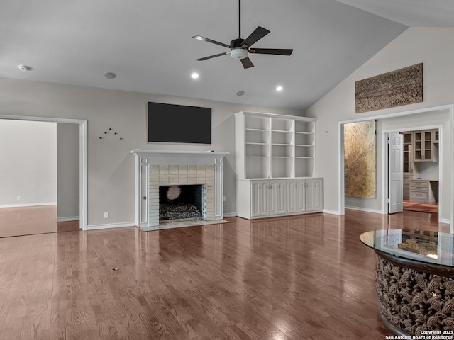 16 Cheshire, San Antonio, TX 78218 - unfurnished living room with a ceiling fan, a fireplace, wood finished floors, baseboards, and recessed lighting
