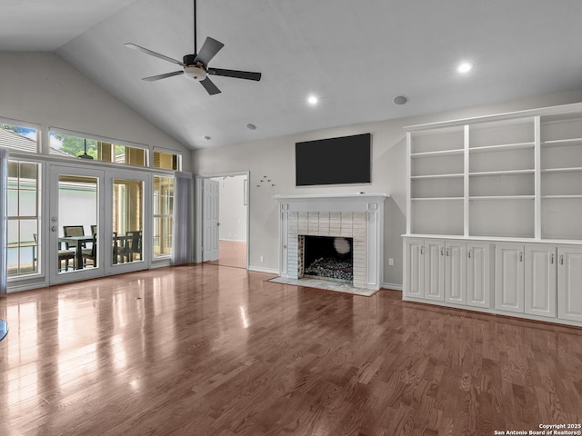 16 Cheshire, San Antonio, TX 78218 - unfurnished living room with ceiling fan, high vaulted ceiling, a brick fireplace, wood finished floors, and recessed lighting