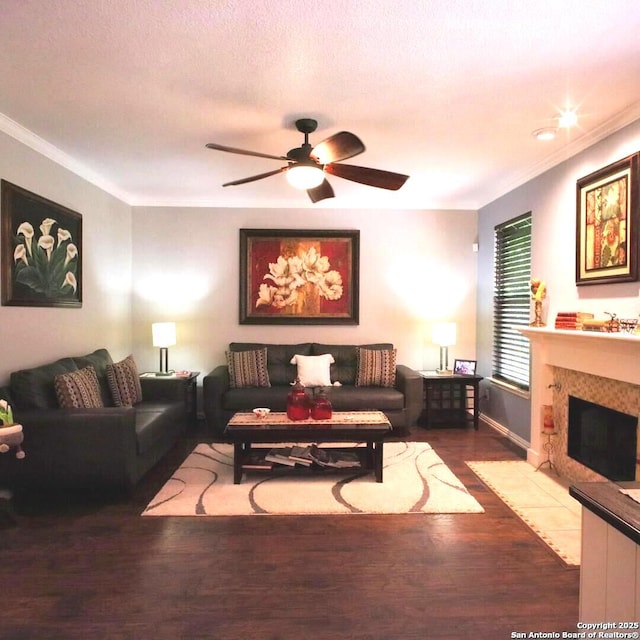 12115 Redbud Leaf, San Antonio, TX 78253 - living area with wood finished floors, ornamental molding, ceiling fan, a tiled fireplace, and baseboards