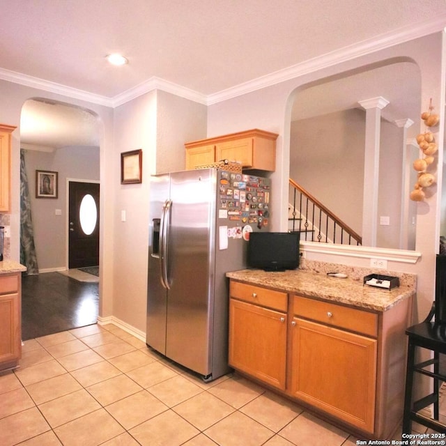 12115 Redbud Leaf, San Antonio, TX 78253 - kitchen featuring stainless steel fridge with ice dispenser, arched walkways, crown molding, light tile patterned floors, and light stone countertops
